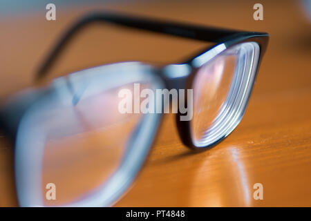Eyeglasses on wooden table Stock Photo