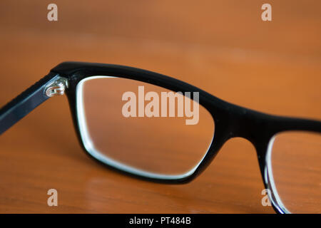 Eyeglasses on wooden table Stock Photo
