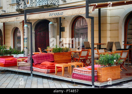 The inviting, outdoor seating patio of the the trendy Flowers restaurant, awaits it's patrons for the evening in the heart of Bratislava, Slovakia Stock Photo