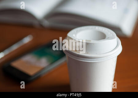 Paper coffee cup on table Stock Photo