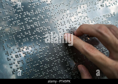 Blind person reading braille text Stock Photo