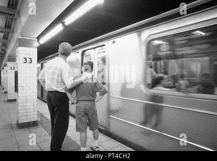 Father and son wait for the subway in New York City, USA Stock Photo