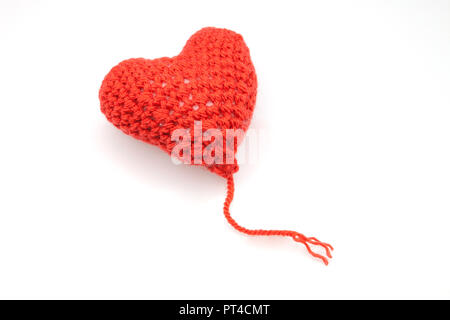Red heart shape symbol made from wool isolated on white background Stock Photo