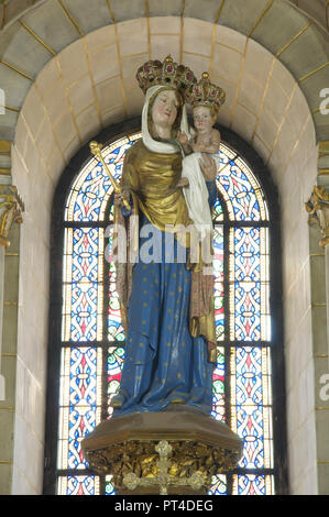 Ornately decorated statue of the Virgin Mary holding the infant Jesus. Both figures are wearing richly bejewelled crowns. Longpont-sur-Orge, France. Stock Photo