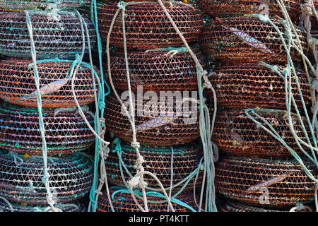 Abstract image of a collection of fishing pots on the sand beside the Atlantic Ocean in Angeiras near Porto in Portugal. Stock Photo