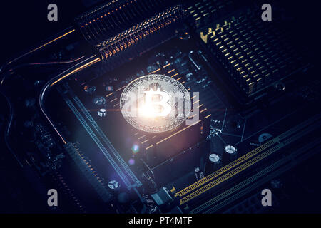 Golden Bitcoin Cryptocurrency on computer circuit board Stock Photo