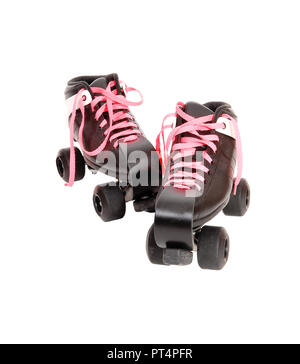 A pair of roller skates sitting on white background with black boots and pink shoe laces and black rollers. Stock Photo