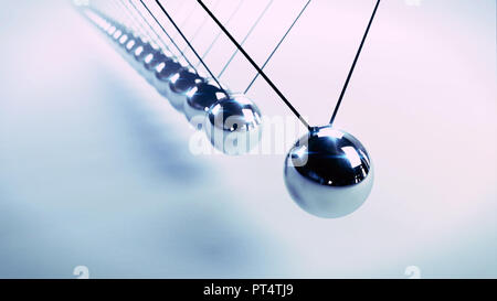 Newton's cradle, action and reaction concept, series of swinging spheres, device that demonstrates conservation of momentum and energy Stock Photo