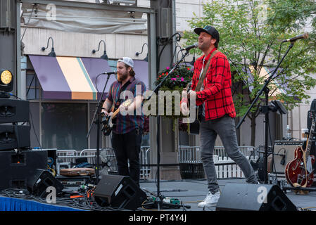 Reston, Virginia--October 6, 2018. An alternative  rock band takes the stage and begins to play at a block party in Reston Virginia. Stock Photo
