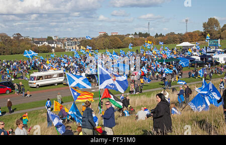 Edinburgh, Scotland, UK. 6th October 2018. 'All Under One Banner March' went ahead with tens of thousands of Scottish supporters waving flags and banners despite a threat of a ban to march into Holyrood Park.  Many had a picnic. The march began at Johnstone Terrace down the Royal Mile and the rally was held in  Holyrood Park. One of the speakers was Tommy Sheridan Socialist Party. Motorcyclists for Independence were applauded through the park by the crowds. Stock Photo