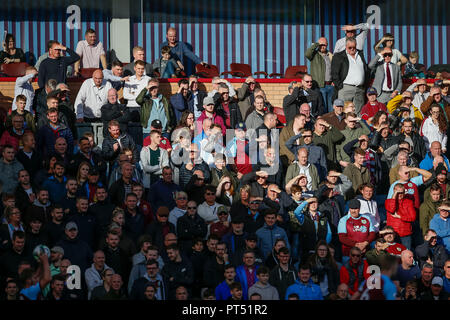 Burnley, UK. 6th Oct 2018. Burnley fans shield their eyes from the sun as they watch on during the Premier League match between Burnley and Huddersfield Town at Turf Moor on October 6th 2018 in Burnley, England. (Photo by Daniel Chesterton/phcimages.com) Credit: PHC Images/Alamy Live News Stock Photo