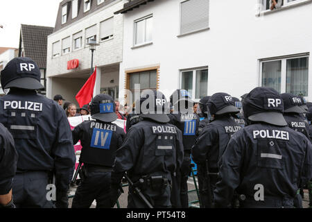 GERMANY Kandel -- 6 October 2018 -- Riot police officers separate the two protests. Around 300 people from right-wing organisations protested for the 14. time in the city of Kandel in Palatinate against refugees, foreigners and the German government. They called for more security of Germans and women from the alleged increased violence by refugees. The place of the protest was chosen because of the 2017 Kandel stabbing attack, in which a 15 year old girl was killed by an asylum seeker. They were confronted by around 400 anti-fascist counter-protesters from different political parties and organ Stock Photo
