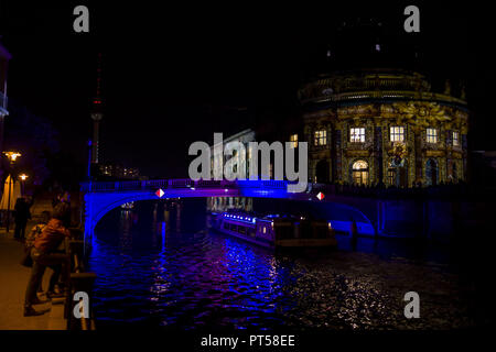 October 6, 2018 - A ship on the river Spree is passing the illuminated Bode-Museum as people are watching during the 14. Festival of Lights in Berlin. Artful displays can be seen on landmarks and buildings across the city through the use of illuminations, luministic projections and 3D mapping. Credit: Jan Scheunert/ZUMA Wire/Alamy Live News Stock Photo