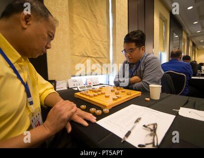 Markham, Canada. 6th Oct, 2018. World Grandmaster (WGM) Jiang Chuan (2nd R) of Team China Wenzhou competes during the 3rd World Xiangqi Team Open in Markham, Canada, Oct. 6, 2018. With above 100 players, 22 teams from around the world, this three-day biennial event kicked off on Saturday in Canada. Credit: Zou Zheng/Xinhua/Alamy Live News Stock Photo