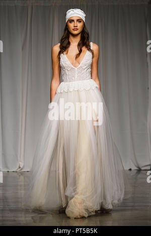 New York, USA. 6th Oct, 2018. A model presents a creation of Lilium Bridal Couture Fall/Winter 2019 collection during the New York Bridal Fashion Week in New York, the United States, Oct. 6, 2018. Credit: Lin Bilin/Xinhua/Alamy Live News Stock Photo