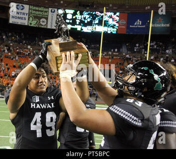 October 6, 2018 - Celebration ensues with the turn over of the Paniolo Trophy after Hawaii won 17-13 in a game between the Hawaii Rainbow Warriors and the Wyoming Cowboys at Aloha Stadium in Honolulu, HI - Michael Sullivan/CSM Stock Photo