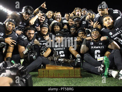 October 6, 2018 - Celebration ensues with the turn over of the Paniolo Trophy after Hawaii won 17-13 in a game between the Hawaii Rainbow Warriors and the Wyoming Cowboys at Aloha Stadium in Honolulu, HI - Michael Sullivan/CSM Stock Photo