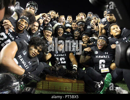 October 6, 2018 - Celebration ensues with the turn over of the Paniolo Trophy after Hawaii won 17-13 in a game between the Hawaii Rainbow Warriors and the Wyoming Cowboys at Aloha Stadium in Honolulu, HI - Michael Sullivan/CSM Stock Photo