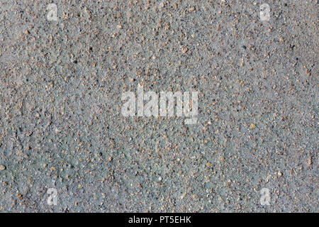 Close-up macro view of gray volcanic sand and small stone surface. Detailed natural background or texture taken in natural environment in crater of ac Stock Photo