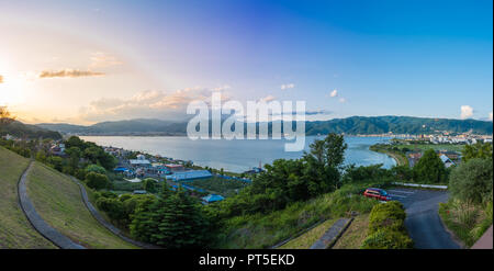 Panorama view of Suwa lake in Nagano, Japan in sunset time with city and mountain background. Landscape photo Stock Photo