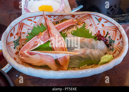 Traditional Japanese Sashimi or raw crab and fish on on a plate is famous and fresh and delicious gourmet in Japan. Stock Photo