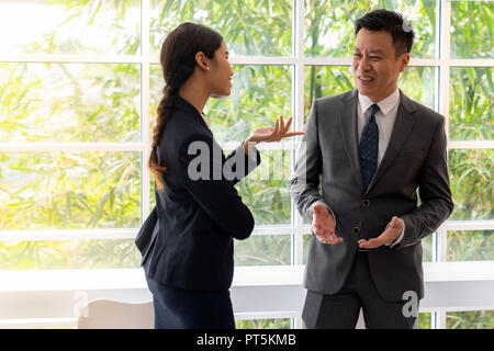 Business people having a conversation near the window in the cafe on coffee time Stock Photo