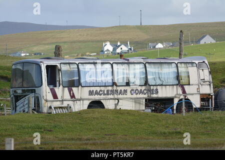 Abandoned travel coach bus left close to beach on a remote island road on the Isle of Harris Outer Hebrides Scotland Stock Photo