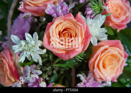 Multicolored roses in a floral wedding decoration . Beautiful bouquet of roses close-up . Pink Rose, beautiful nature background . Artificial roses on table,Love valentine concept Stock Photo