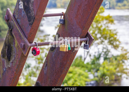 Love locks on Appalachian Trail walkway on railroad bridge over Upper Potomac River in Harpers Ferry National Historical Park in West Virginia Stock Photo