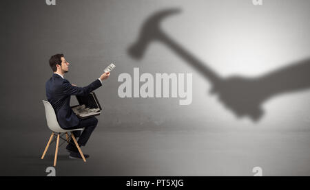 Small businessman staying and offering stuffs for an armed shadow hand  Stock Photo