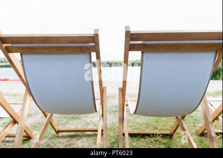 Two wooden lounge relax chairs from back Stock Photo