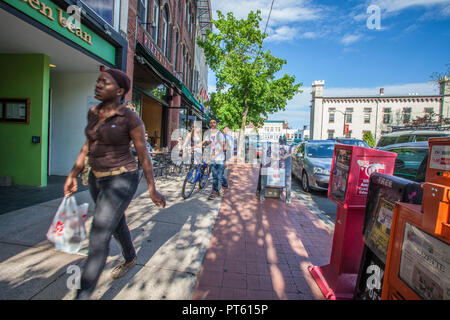 People walking along the sidewalk on busy Main Street in Northampton, MA Stock Photo