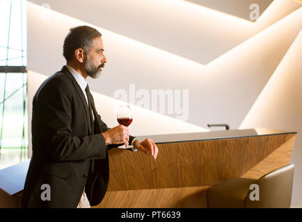 Portrait of senior handsome man drinking red wine Stock Photo