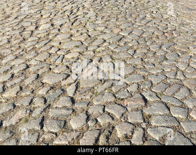 Rough surface of an old cobblestone road Stock Photo