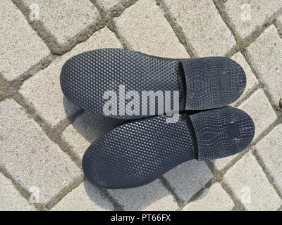 New sole of man's shoe lying on a pavement Stock Photo