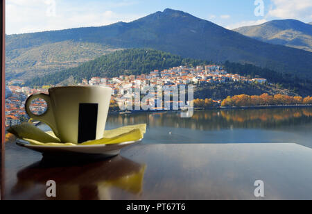 Cup of coffee with window view of Kastoria , Greece Stock Photo