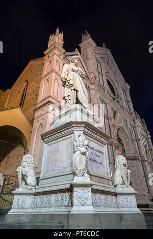 Sculpture of Dante Alighieri in the background of the Basilica of Santa Croce and the night sky. Florence. Italy Stock Photo