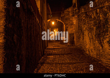 Europe, Italy, Varenna, Lake Como, ILLUMINATED STREET LIGHT ON FOOTPATH AMIDST BUILDINGS Stock Photo