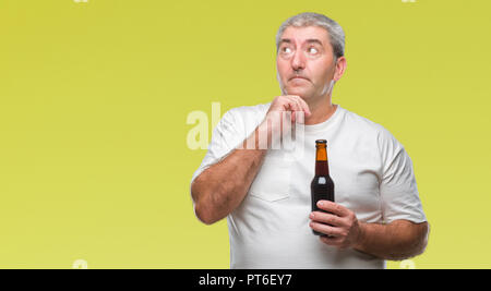 Handsome senior man drinking beer bottle over isolated background serious face thinking about question, very confused idea Stock Photo