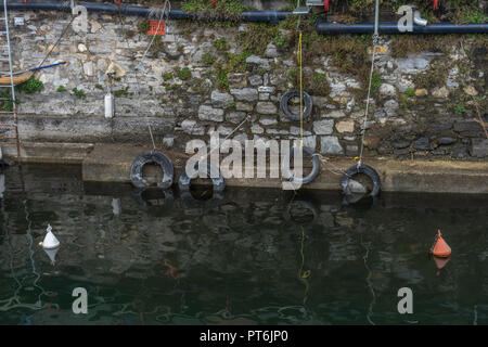 Italy, Varenna, Lake Como, a flock of tyres sitting on the side of a building Stock Photo