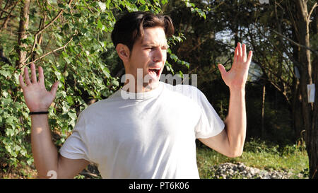 Young man frustrated for too much noise in nature Stock Photo