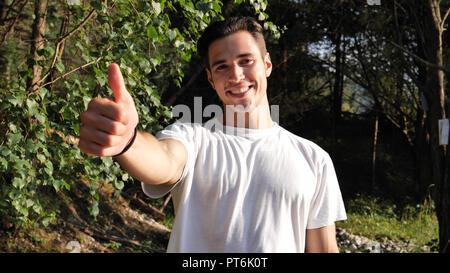 Young man in nature doing thumb up Stock Photo