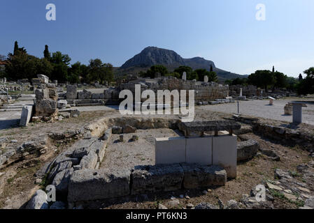 View of the Heroon of the Crossroads, the Bema is in the background. Ancient Corinth. Peloponnese. Greece. Ancient Corinth was one of the most influen Stock Photo