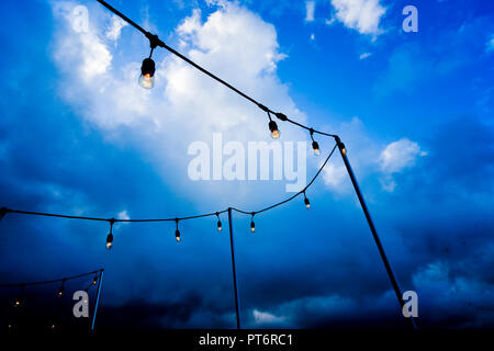 Outdoor party lights in cloudy weather Stock Photo