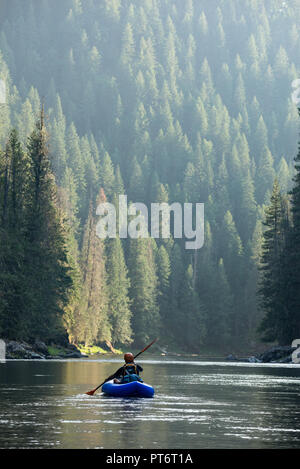 Paddling an inflatable kayak on a calm section of Idaho's Selway River. Stock Photo