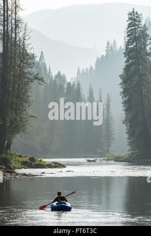 Paddling an inflatable kayak on a calm section of Idaho's Selway River. Stock Photo