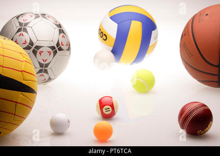 Assorted sports balls on a black background Stock Photo - Alamy