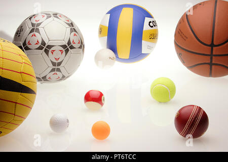 Assorted sports balls on a black background Stock Photo - Alamy