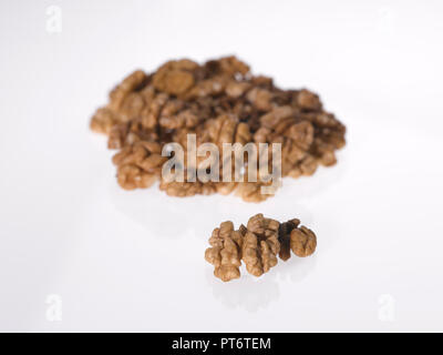 a still life of walnuts against a plain background Stock Photo
