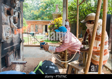 TAMIL NADU, INDIA - April 2018: Soda firing process in pottery production Stock Photo